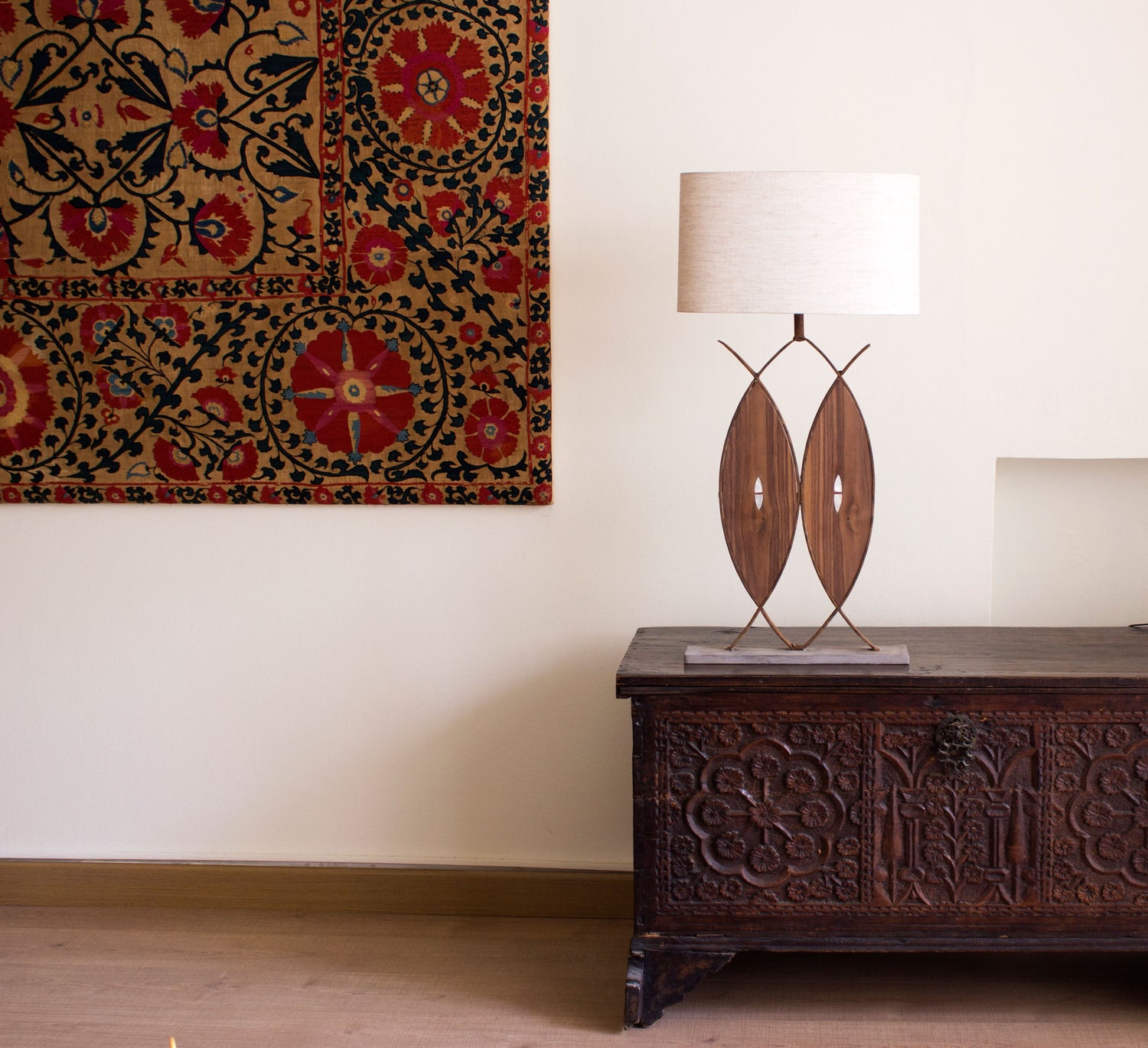 handmade wrought iron lamp with carved wooden details