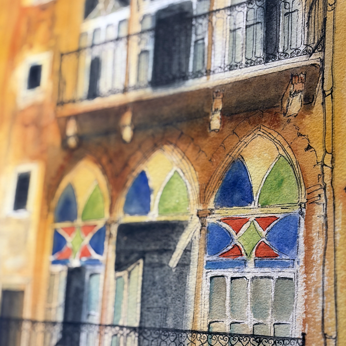Colorful architectural detail of a building with arched windows and decorative elements.