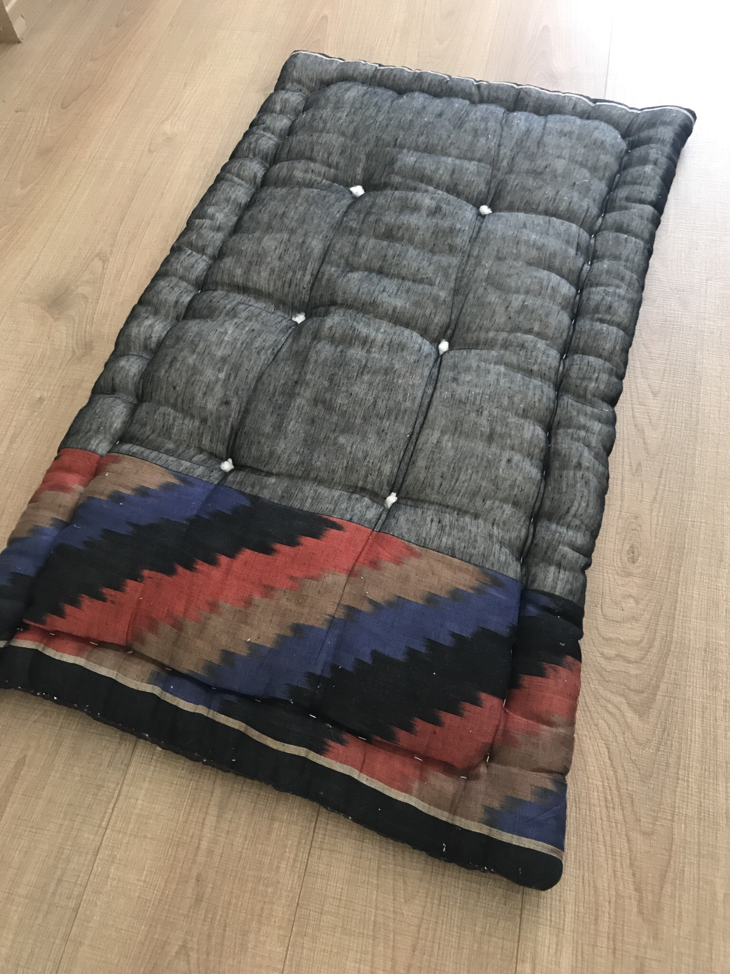 Quilted mattress black ikat.